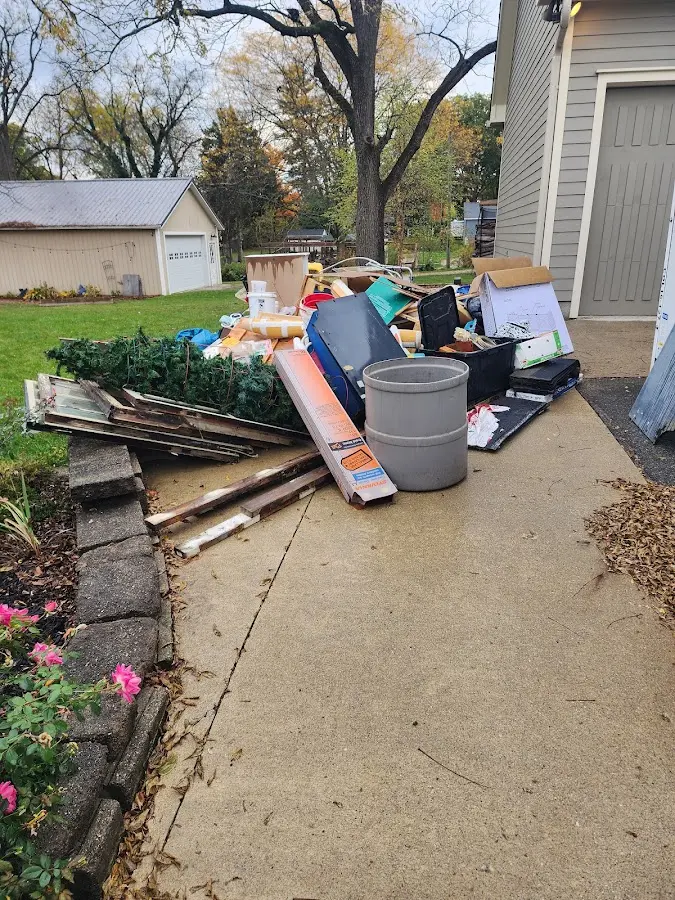 Dumpster being loaded with debris for Residential Dumpster Rental in Sappington